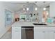 Open-concept kitchen with granite countertops and stainless steel appliances overlooking dining and living areas at 6517 Approach Rd # 57, Sarasota, FL 34238