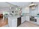 Open-concept kitchen with stainless steel appliances, a spacious island, and hardwood floors at 6517 Approach Rd # 57, Sarasota, FL 34238