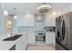 Bright kitchen featuring stainless steel appliances, granite countertops, and modern lighting at 6517 Approach Rd # 57, Sarasota, FL 34238