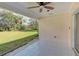 Covered outdoor patio overlooks backyard with a view of lush green lawn at 6517 Approach Rd # 57, Sarasota, FL 34238