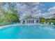 Community pool with ample seating and a clubhouse in a lush, landscaped setting at 6517 Approach Rd # 57, Sarasota, FL 34238