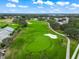 Aerial view of the manicured golf course with beautiful landscaping, sand traps, and a view of the neighborhood in the distance at 6524 Fairway Gardens Dr # 6524, Bradenton, FL 34203