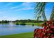 Scenic view of the lake with water fountain feature, surrounded by the golf course landscaping and the beautiful community at 6524 Fairway Gardens Dr # 6524, Bradenton, FL 34203