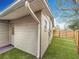 View of the house with a well-maintained exterior, green grass, and new-looking fence at 6772 113Th St, Seminole, FL 33772