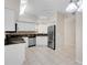 Well-lit kitchen featuring white cabinetry, stainless steel appliances, and granite countertops at 7603 Sweetbay Cir # 5-101, Bradenton, FL 34203