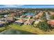 Aerial view showcases a neighborhood with mature trees and lake views at 8079 36Th Street E Cir, Sarasota, FL 34243