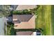 Aerial view highlighting the roof and landscaping, located on a pond at 8079 36Th Street E Cir, Sarasota, FL 34243