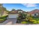 Inviting home exterior with manicured landscaping, a tile roof, and a striking front door at 8079 36Th Street E Cir, Sarasota, FL 34243