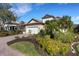 Beautiful home with a paved driveway and carefully arranged flowerbeds in the front yard at 8079 36Th Street E Cir, Sarasota, FL 34243