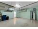Spacious garage with ample storage, painted floors, and access to laundry at 8079 36Th Street E Cir, Sarasota, FL 34243