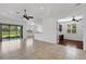 Open living room with tile floors and views of the lake through expansive sliding glass doors at 8079 36Th Street E Cir, Sarasota, FL 34243