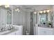 Bathroom with granite countertops, white cabinets, and a large walk-in shower at 8548 Snowfall St, Sarasota, FL 34241