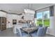 Open concept dining area adjacent to kitchen with large windows at 8548 Snowfall St, Sarasota, FL 34241