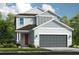 Two-story home with gray siding, red door, and a two-car garage at 8548 Snowfall St, Sarasota, FL 34241