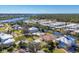 Picturesque aerial view of a waterfront neighborhood next to canal and green spaces at 907 Garland Ave, Nokomis, FL 34275