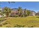 The tropical landscaping surrounds the home's backyard and screened-in lanai area at 907 Garland Ave, Nokomis, FL 34275
