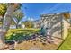 View of a storage shed in a spacious, landscaped backyard with access to the screened-in pool area at 907 Garland Ave, Nokomis, FL 34275