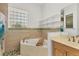 Bathroom with a bathtub, a shower and a large window for natural light at 907 Garland Ave, Nokomis, FL 34275