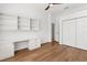 Bright bedroom features built-in desk, shelving, and a closet for ample storage space at 907 Garland Ave, Nokomis, FL 34275