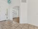 Inviting foyer featuring tile flooring, arched doorway, and ample natural light at 907 Garland Ave, Nokomis, FL 34275