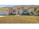 Exterior view of a home featuring a manicured lawn and a welcoming front entrance at 907 Garland Ave, Nokomis, FL 34275