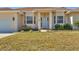 Well-maintained home exterior with a tidy lawn, tasteful landscaping, and a charming front porch at 907 Garland Ave, Nokomis, FL 34275