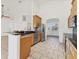 Modern kitchen with stainless appliances, breakfast bar, and archway to the dining room at 907 Garland Ave, Nokomis, FL 34275
