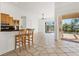 Bright kitchen with breakfast bar opens to the patio and pool area through sliding glass doors at 907 Garland Ave, Nokomis, FL 34275