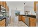 Modern kitchen with stainless appliances, granite countertops, and a view of the pool at 907 Garland Ave, Nokomis, FL 34275