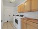 Functional laundry room with modern washer and dryer, ample cabinet and storage space at 907 Garland Ave, Nokomis, FL 34275