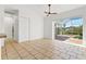 Bright room with tile floors and sliding glass doors leading to screened in patio at 907 Garland Ave, Nokomis, FL 34275