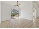Bright living room with tile floors and sliding glass doors leading to screened in pool at 907 Garland Ave, Nokomis, FL 34275