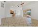 Open living area with tiled floors, bar seating, and a view of the screened lanai and pool at 907 Garland Ave, Nokomis, FL 34275