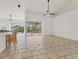 An open living space featuring tile floors, an island bar, and access to a screened lanai and pool at 907 Garland Ave, Nokomis, FL 34275