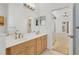 Main bathroom featuring dual sinks, vanity and a sliding door leading to the main bedroom at 907 Garland Ave, Nokomis, FL 34275