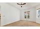 A main bedroom with a ceiling fan and French doors leading to the backyard pool at 907 Garland Ave, Nokomis, FL 34275