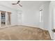 Spacious main bedroom with a ceiling fan, two windows, and sliding glass doors to the balcony at 907 Garland Ave, Nokomis, FL 34275