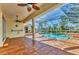 Relaxing outdoor pool area with screened-in enclosure and tile flooring at 907 Garland Ave, Nokomis, FL 34275