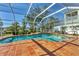 Relaxing screened pool with waterfall feature, providing a serene backyard escape at 907 Garland Ave, Nokomis, FL 34275