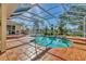 Inviting screened pool features a waterfall and tile surround, creating a relaxing outdoor oasis at 907 Garland Ave, Nokomis, FL 34275