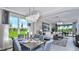 Bright dining room with large windows, chandelier, and seating for six at 9113 Night Skye Ave, Sarasota, FL 34241