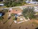 Aerial view of the home with a large backyard, patio, landscaping and mature trees at 1058 Bounds St, Port Charlotte, FL 33952