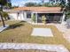 Backyard with green grass, decorative stones, patio and well manicured landscaping at 1058 Bounds St, Port Charlotte, FL 33952