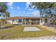 A spacious backyard with a screen patio, a well-maintained lawn and mature landscaping at 1058 Bounds St, Port Charlotte, FL 33952