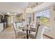 Bright breakfast nook with a glass table set and decorative window treatments at 1058 Bounds St, Port Charlotte, FL 33952