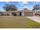 Charming single-story home with a well-maintained lawn and attached two-car garage at 1058 Bounds St, Port Charlotte, FL 33952