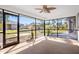 Enjoy the beautiful backyard view from the screened-in patio with ceiling fan at 1058 Bounds St, Port Charlotte, FL 33952