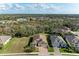 Beautiful aerial view showcasing the home's location amongst lush greenery and a serene lake at 12514 Goldenrod Ave, Bradenton, FL 34212