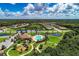 Expansive aerial view showcasing the community's layout with lush greenery, serene ponds, and a sparkling pool area at 12514 Goldenrod Ave, Bradenton, FL 34212