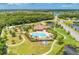 Spacious community with pool, playground, landscaping and ponds with mature trees in background at 12514 Goldenrod Ave, Bradenton, FL 34212